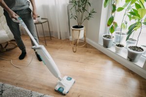 man-cleaning-the-living-room-with-steam-mop-2026-01-06-09-33-41-utc
